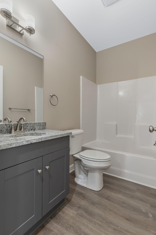 871 Blessings Way, Gallatin, TN 37066 - full bath featuring baseboards, toilet, vanity, wood finished floors, and washtub / shower combination