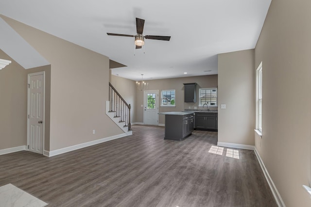 871 Blessings Way, Gallatin, TN 37066 - unfurnished living room with baseboards, stairs, ceiling fan with notable chandelier, dark wood-style floors, and a sink