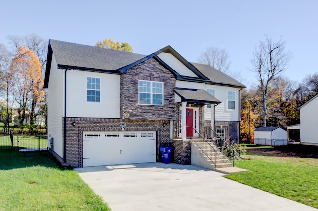 view of front facade with driveway, a front lawn, fence, a garage, and brick siding