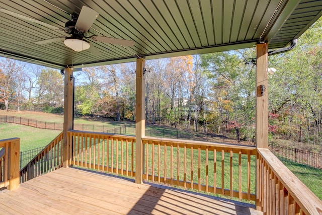 wooden terrace featuring a lawn, a ceiling fan, and a fenced backyard