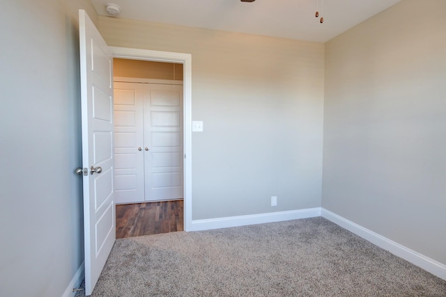 unfurnished bedroom featuring carpet flooring and baseboards