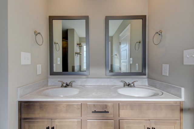 full bathroom featuring double vanity and a sink