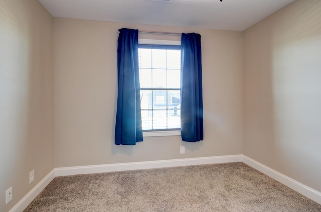 empty room with visible vents, baseboards, and carpet flooring