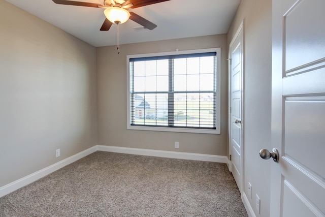 unfurnished room featuring a ceiling fan, baseboards, and carpet floors