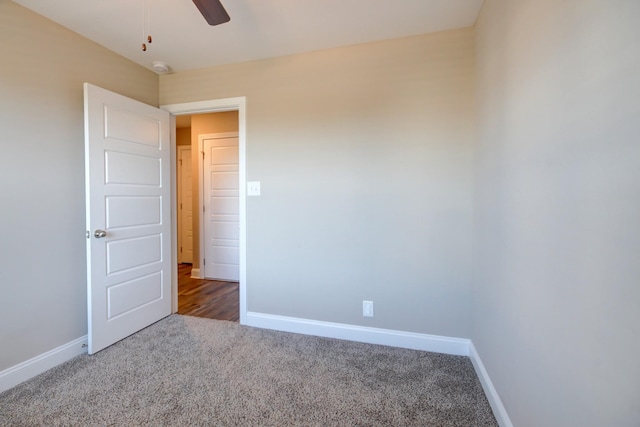 unfurnished bedroom with carpet flooring, a ceiling fan, and baseboards