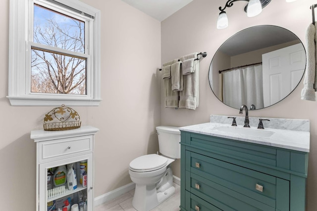 full bathroom featuring tile patterned floors, toilet, vanity, and baseboards