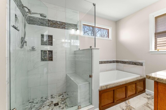 full bathroom featuring a garden tub, marble finish floor, a stall shower, and vanity