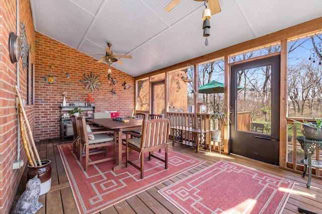 sunroom featuring ceiling fan and vaulted ceiling