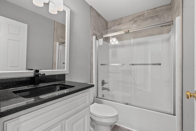 928 Red Bird Ln, Cumberland Furnace, TN 37051 - bathroom featuring bath / shower combo with glass door, vanity, and toilet