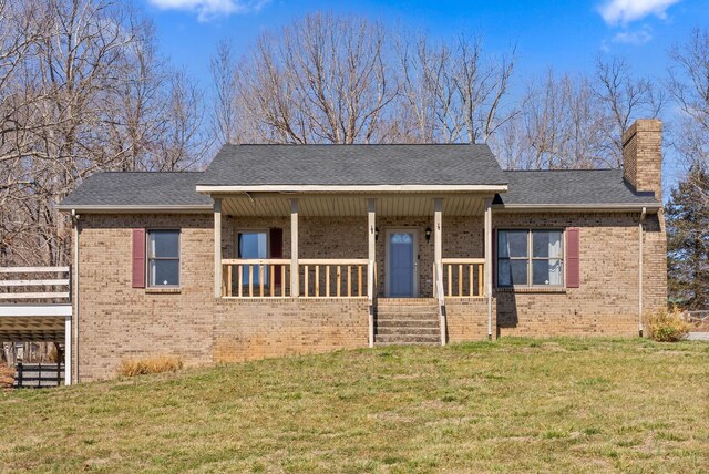 928 Red Bird Ln, Cumberland Furnace, TN 37051 - view of front facade with brick siding, a front lawn, covered porch, and a chimney