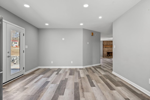 928 Red Bird Ln, Cumberland Furnace, TN 37051 - empty room featuring recessed lighting, baseboards, light wood-style floors, and a fireplace