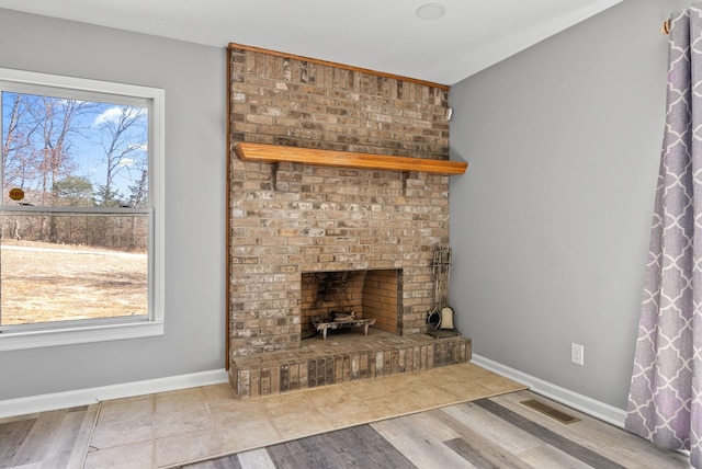 928 Red Bird Ln, Cumberland Furnace, TN 37051 - unfurnished living room with baseboards, visible vents, plenty of natural light, and a brick fireplace