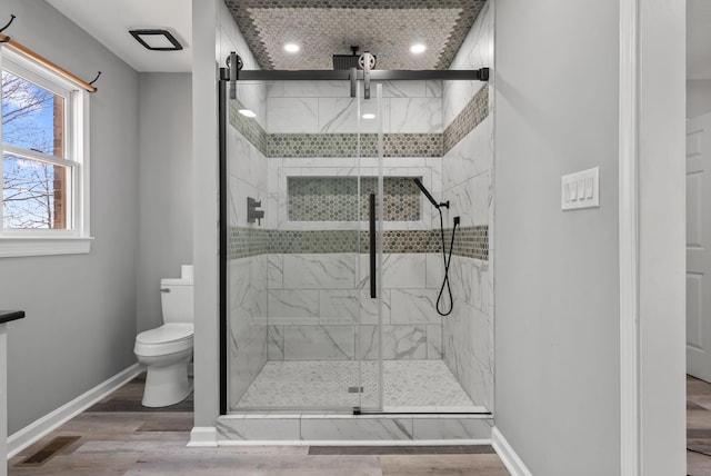 928 Red Bird Ln, Cumberland Furnace, TN 37051 - full bathroom with wood finished floors, baseboards, visible vents, a marble finish shower, and toilet