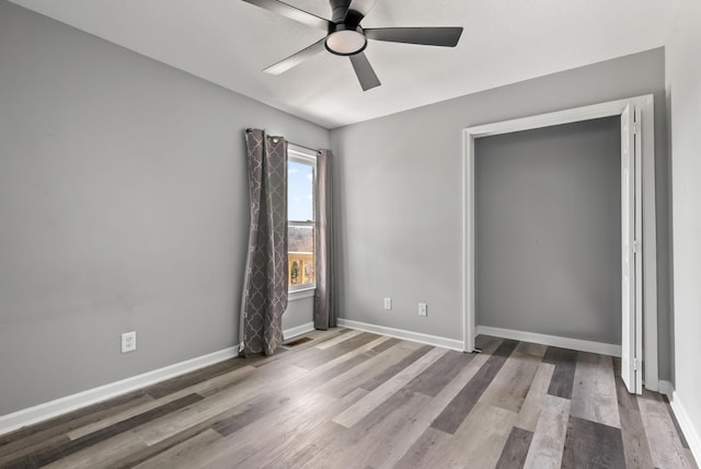 928 Red Bird Ln, Cumberland Furnace, TN 37051 - unfurnished bedroom with ceiling fan, baseboards, and wood finished floors