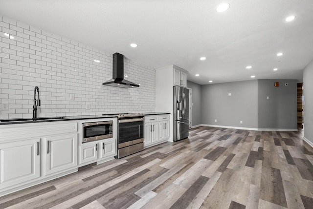 928 Red Bird Ln, Cumberland Furnace, TN 37051 - kitchen with a sink, stainless steel appliances, dark countertops, and wall chimney range hood