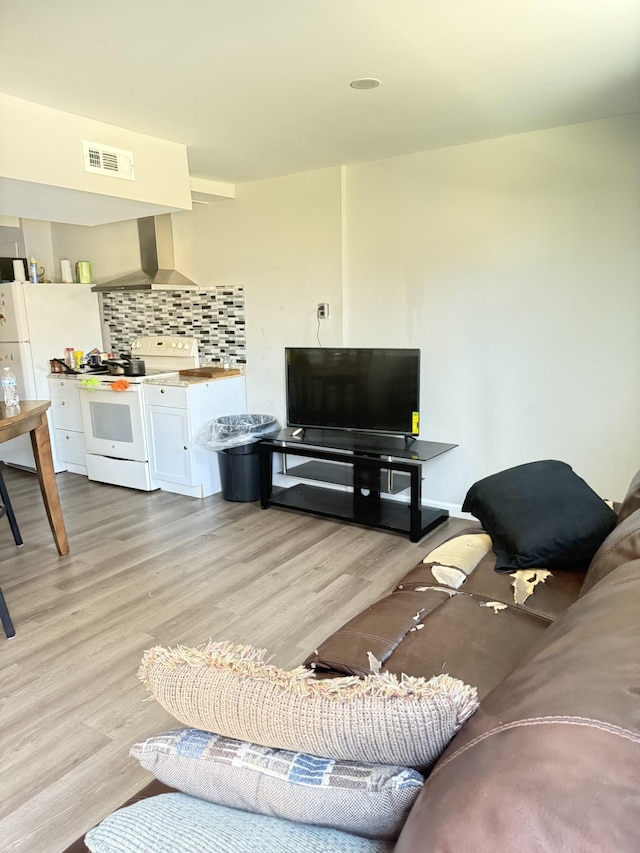 living room with visible vents and light wood-style floors