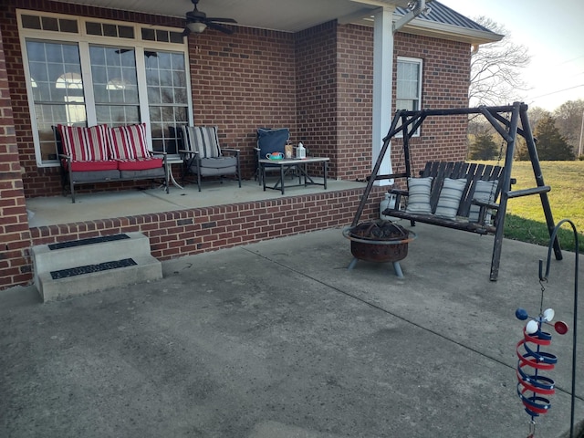 view of patio with an outdoor fire pit and ceiling fan