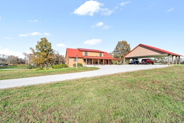 view of front facade featuring metal roof, a carport, and a front yard