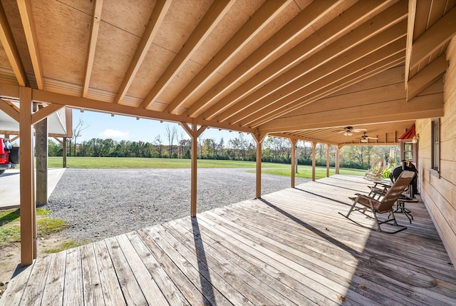 wooden deck featuring a lawn