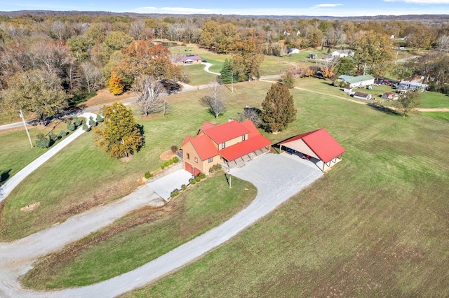 drone / aerial view featuring a wooded view