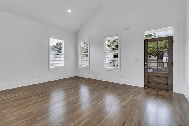 entrance foyer with dark wood-style floors, baseboards, and high vaulted ceiling