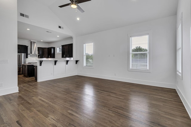 unfurnished living room featuring visible vents, baseboards, dark wood-type flooring, and a ceiling fan