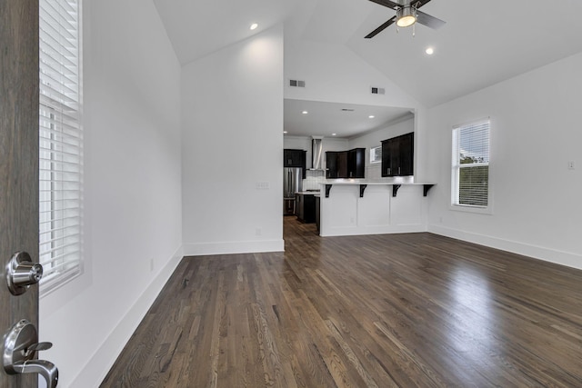 unfurnished living room featuring visible vents, baseboards, dark wood-style floors, and a ceiling fan