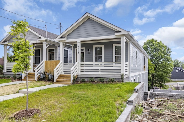 view of front of house with a porch and a front lawn