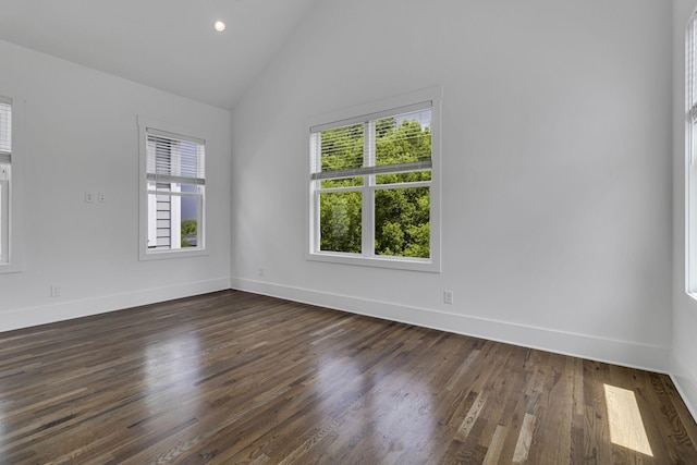 empty room featuring recessed lighting, baseboards, dark wood-style flooring, and vaulted ceiling