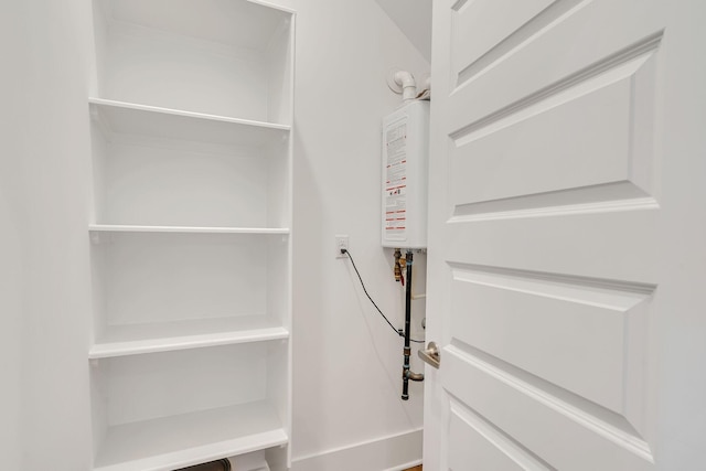 pantry featuring tankless water heater