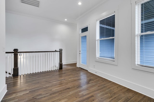 unfurnished room with visible vents, ornamental molding, wood finished floors, recessed lighting, and baseboards