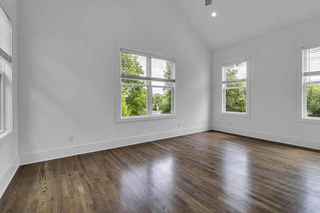 unfurnished room with dark wood finished floors, lofted ceiling, recessed lighting, and baseboards