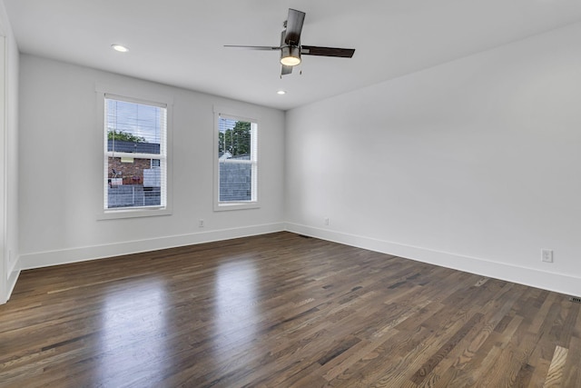 empty room featuring recessed lighting, baseboards, dark wood finished floors, and a ceiling fan