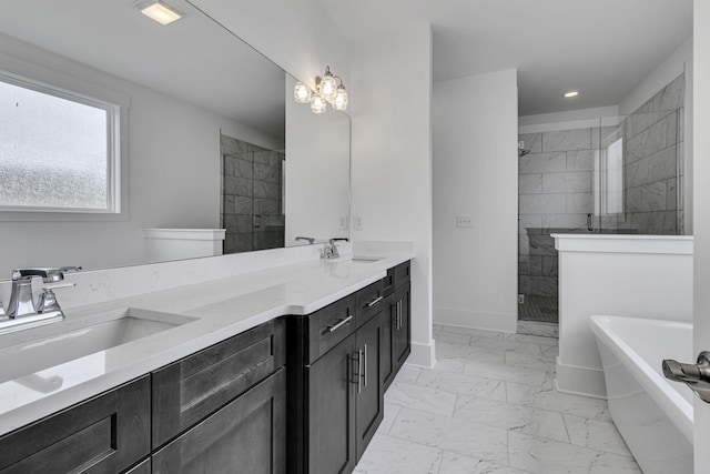 full bath featuring a sink, marble finish floor, a shower stall, and double vanity