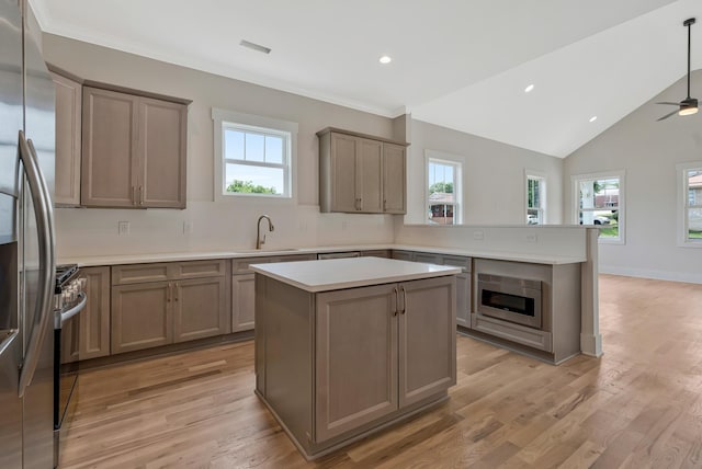 904 32nd Ave N Unit A, Nashville, TN 37209 - kitchen featuring appliances with stainless steel finishes, a peninsula, plenty of natural light, recessed lighting, and light countertops