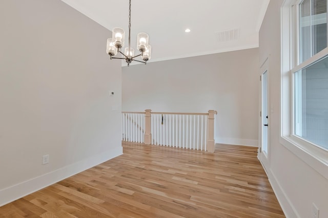 904 32nd Ave N Unit A, Nashville, TN 37209 - spare room with crown molding, a chandelier, and light wood-style flooring