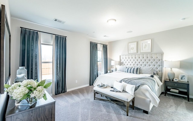 bedroom with visible vents, baseboards, and carpet