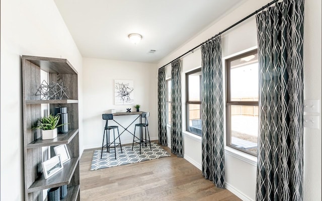 interior space with baseboards and wood finished floors