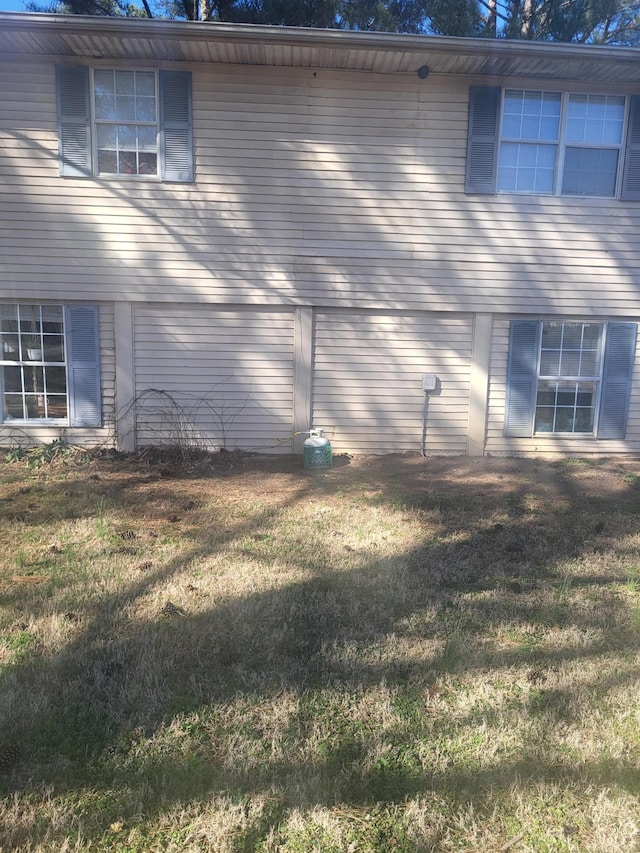 view of side of home featuring a lawn