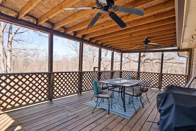 sunroom / solarium featuring a ceiling fan and a wealth of natural light