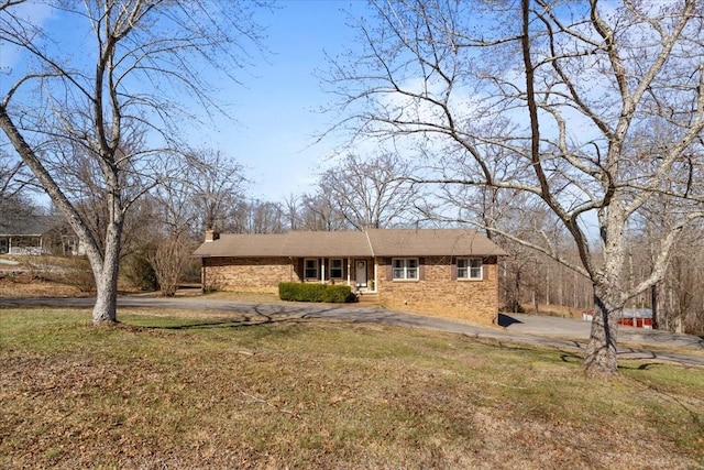 view of front of property featuring a front yard and a chimney