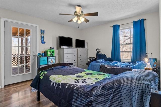 bedroom with a textured ceiling, ceiling fan, and wood finished floors