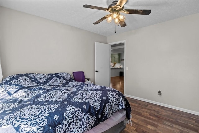 bedroom featuring baseboards, a textured ceiling, and wood finished floors