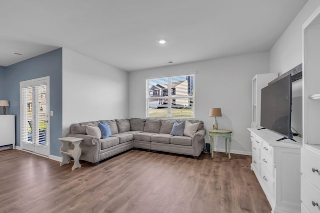 living area with wood finished floors and baseboards