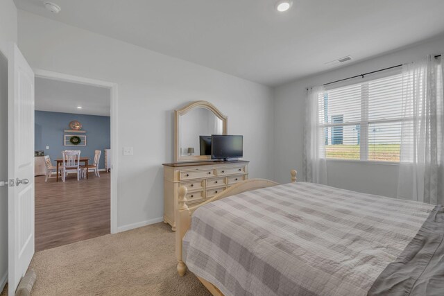 bedroom featuring visible vents, baseboards, and carpet