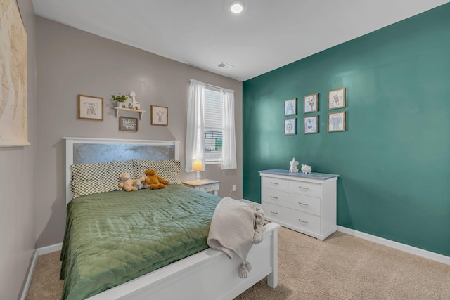 bedroom with visible vents, baseboards, and light carpet