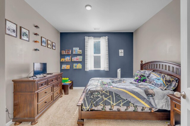 bedroom featuring visible vents, baseboards, and carpet floors