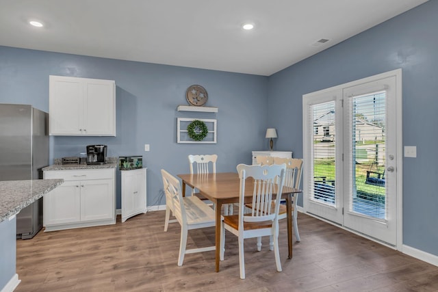 dining area featuring light wood-type flooring, visible vents, baseboards, and recessed lighting