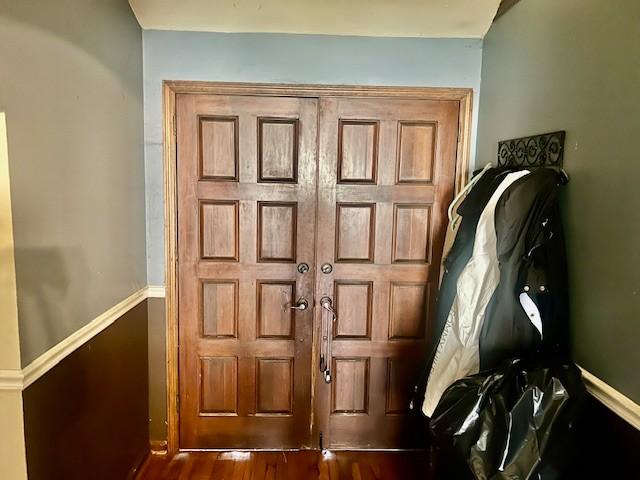 entryway with dark wood-style floors