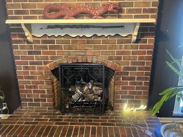 room details featuring a brick fireplace